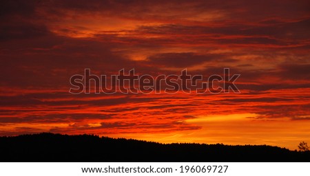 Dramatic sunset with alpenglow over the forest