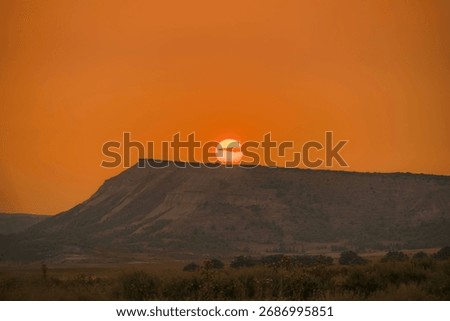 Dramatic Sunset Behind Mesa Formation in Bardenas Reales Desert, Navarra Spain, Orange Sky, Silhouette Landscape, Natural Park, Golden Hour, Badlands