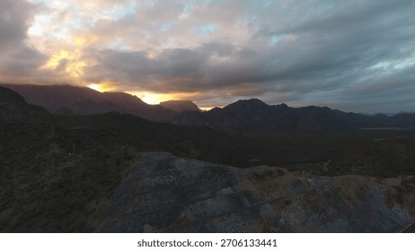 Dramatic sunset behind mountain silhouette with glowing sky