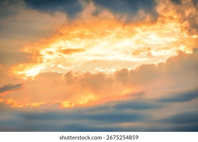 Dramatic sunset clouds creating a vivid canvas of vibrant colors in the evening sky over a tranquil landscape