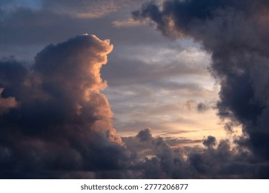 Dramatic sunset clouds with golden light and dark storm formations