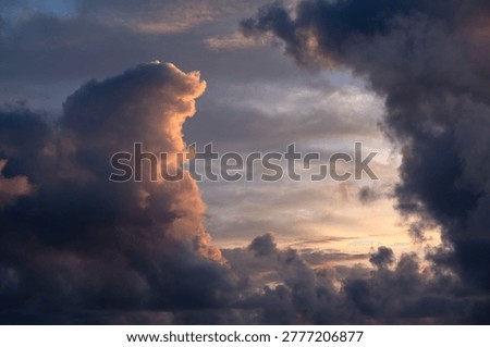 Dramatic sunset clouds with golden light and dark storm formations