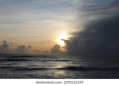 Dramatic sunset with clouds with orange sky on a sand beach over the Indian Ocean in Sri Lanka