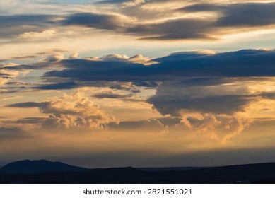 Dramatic sunset clouds over distant mountains