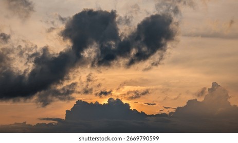 Dramatic Sunset Cloudscape: Golden Hour Light Breaks Through Dark Cumulus Clouds
