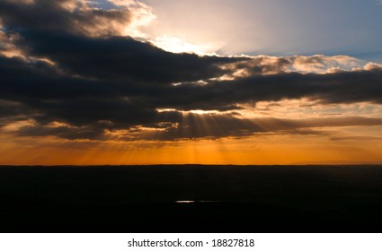 dramatic sunset with dark clouds and sun rays