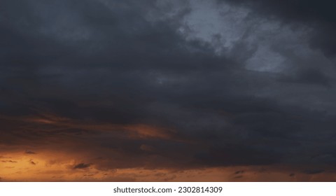 Dramatic sunset with dark stormy clouds