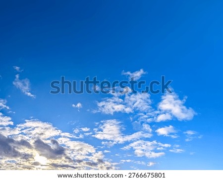 A dramatic sunset in evening colors of orange, red, and blue. Breathtaking picture celestial interplay of warm and cool tones. Setting sun gives warm yellow gleam horizon. Big copy space for my text.