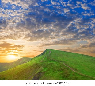 dramatic sunset in a green hills