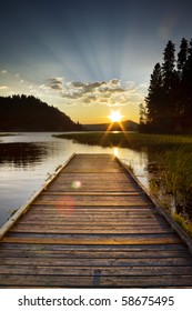 Dramatic Sunset Of A Lake Looking Off A Dock