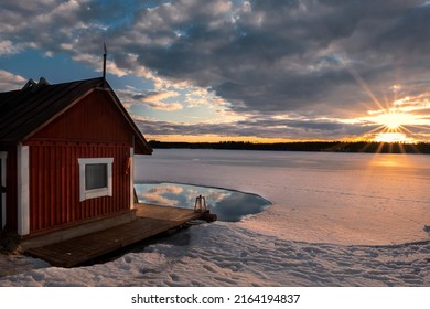 dramatic sunset in linkkumylly finland over a frozen lake - natural landscape photography