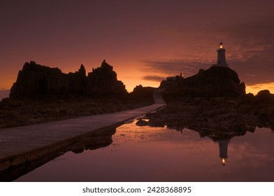 Dramatic sunset, low tide, corbiere lighthouse, st. ouens, jersey, channel islands, united kingdom, europe - Powered by Shutterstock