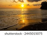 Dramatic sunset on Amed beach with black sand