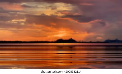 dramatic sunset orange gold lilac clouds on dark sky sunbeam sea wave light reflection seascape landscape Baltic on horizon boat