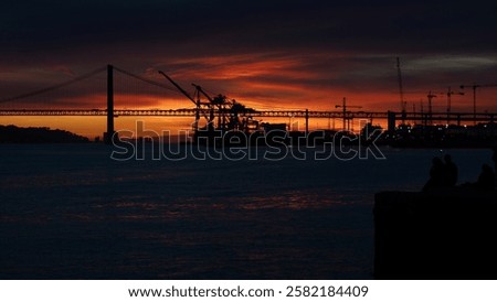 Dramatic Sunset Over 25 de Abril Bridge and Industrial Port in Lisbon