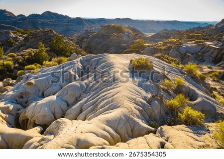 A dramatic sunset over the badlands formations of Makoshika State Park as seen from the Cap Rock Trail