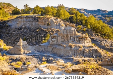 A dramatic sunset over the badlands formations of Makoshika State Park as seen from the Cap Rock Trail