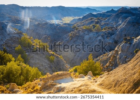A dramatic sunset over the badlands formations of Makoshika State Park as seen from the Cap Rock Trail
