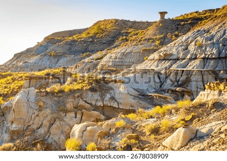 A dramatic sunset over the badlands formations of Makoshika State Park as seen from the Cap Rock Trail