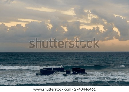 Dramatic Sunset Over Bali Coastline with Ocean Waves
