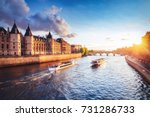 Dramatic sunset over Cite in Paris, France, with Conciergerie, Pont Neuf and river Seine. Colourful travel background. Romantic cityscape.