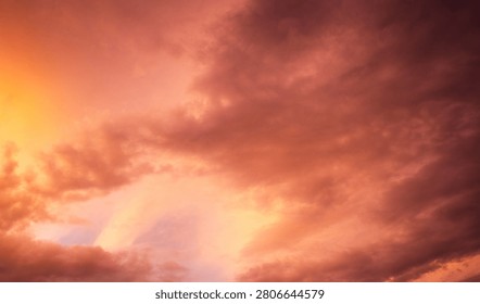 Dramatic sunset over a dark landscape with fiery clouds, atmosph