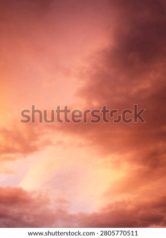 Dramatic sunset over a dark landscape with fiery clouds, atmosph