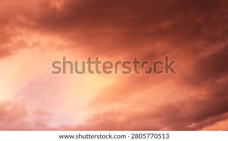 Dramatic sunset over a dark landscape with fiery clouds, atmosph
