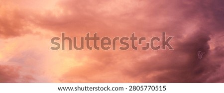 Dramatic sunset over a dark landscape with fiery clouds, atmosph