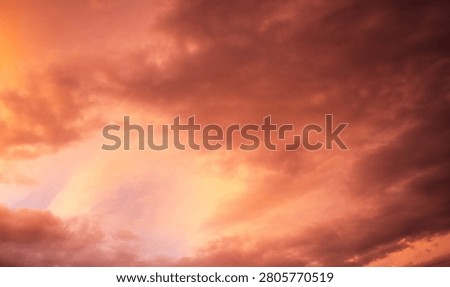Dramatic sunset over a dark landscape with fiery clouds, atmosph