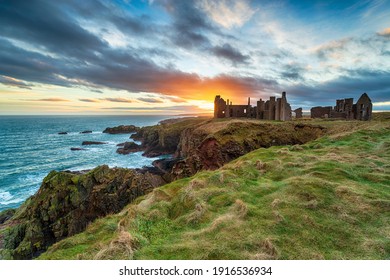 Dramatic sunset over the eerie ruins Slains Castle near Peterhead on the east coast of Scotland - Powered by Shutterstock