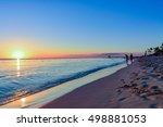 Dramatic sunset over the exotic beach, Punta Cana,  Dominican Republic, with palms and white sand beaches for a relaxing beach