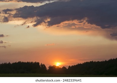 Dramatic sunset over the fields. Agricultural landscape in eastern Lithuania.