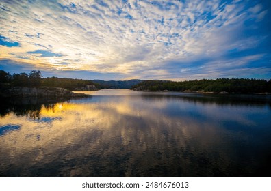 Dramatic Sunset over the granite rock shoreline of the clear water lake, Killarney Provincial Park, Ontario, Canada, summer night  - Powered by Shutterstock