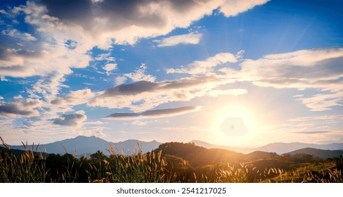 Dramatic sunset over mountain landscape. Beautiful landscape foggy hills twilight time. Blue golden sky sunrise dramatic beautiful landscape mountain. Dawn sky gold dusk time cloudscape with sunlight