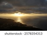 Dramatic sunset over the Pacific Ocean, Oahu, Hawaii – golden light, clouds, and breathtaking coastal scenery from a high viewpoint.