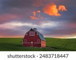 Dramatic sunset over a red barn in the Palouse in eastern Washington state