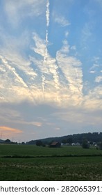 Dramatic sunset over rural fields and rolling hills