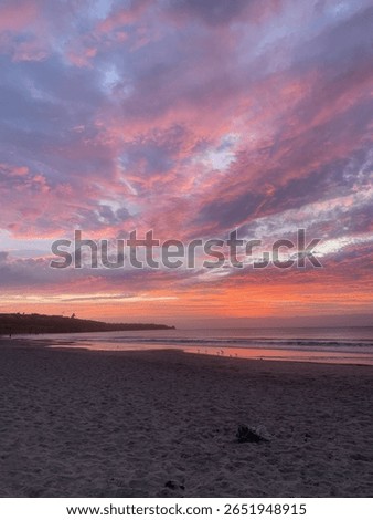 Dramatic sunset over sandy beach.
vibrant pink and purple clouds fill the sky above a peaceful beach at sunset. The colorful seascape creates a serene and inspiring atmosphere.