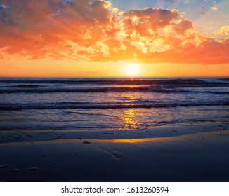 dramatic sunset over the sandy sea beach, dramatic outdoor background