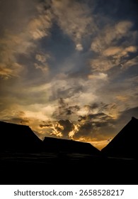 Dramatic Sunset Over Silhouetted Rooftops With Vibrant Contrast