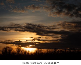 Dramatic sunset over the Vistula River, with fiery skies, silhouetted trees, and dynamic clouds creating a captivating and atmospheric scene - Powered by Shutterstock