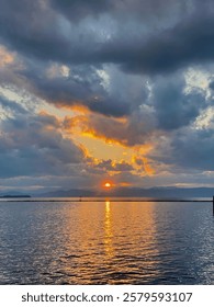 Dramatic Sunset Over Water

A breathtaking sunset over a calm body of water, with the sun’s golden reflection shimmering on the surface. 