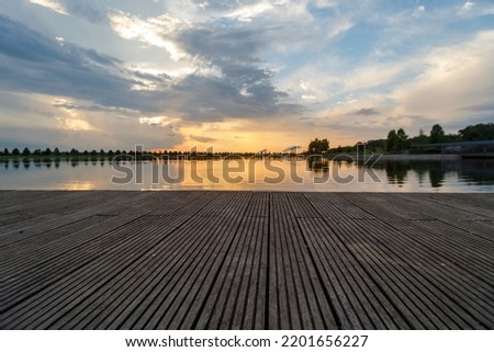 Dramatic sunset and reflections on the water on Patriot Lake in Shelby Farms Park, Memphis, TN.