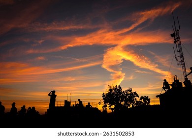 Dramatic Sunset Scene with Human Silhouettes