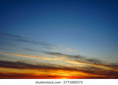 A dramatic sunset in a sky of bright orange and red hues