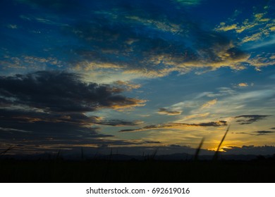 Dramatic sunset sky with clouds.