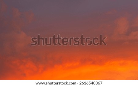 Dramatic sunset sky clouds background in the evening with red, orange, yellow and pink sunlight on golden hour after sundown, Romantic sky in summer on dusk 