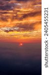 Dramatic sunset sky with clouds during flight 