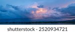 dramatic sunset sky and  clouds over Rocky Mountains and lake in northern Colorado